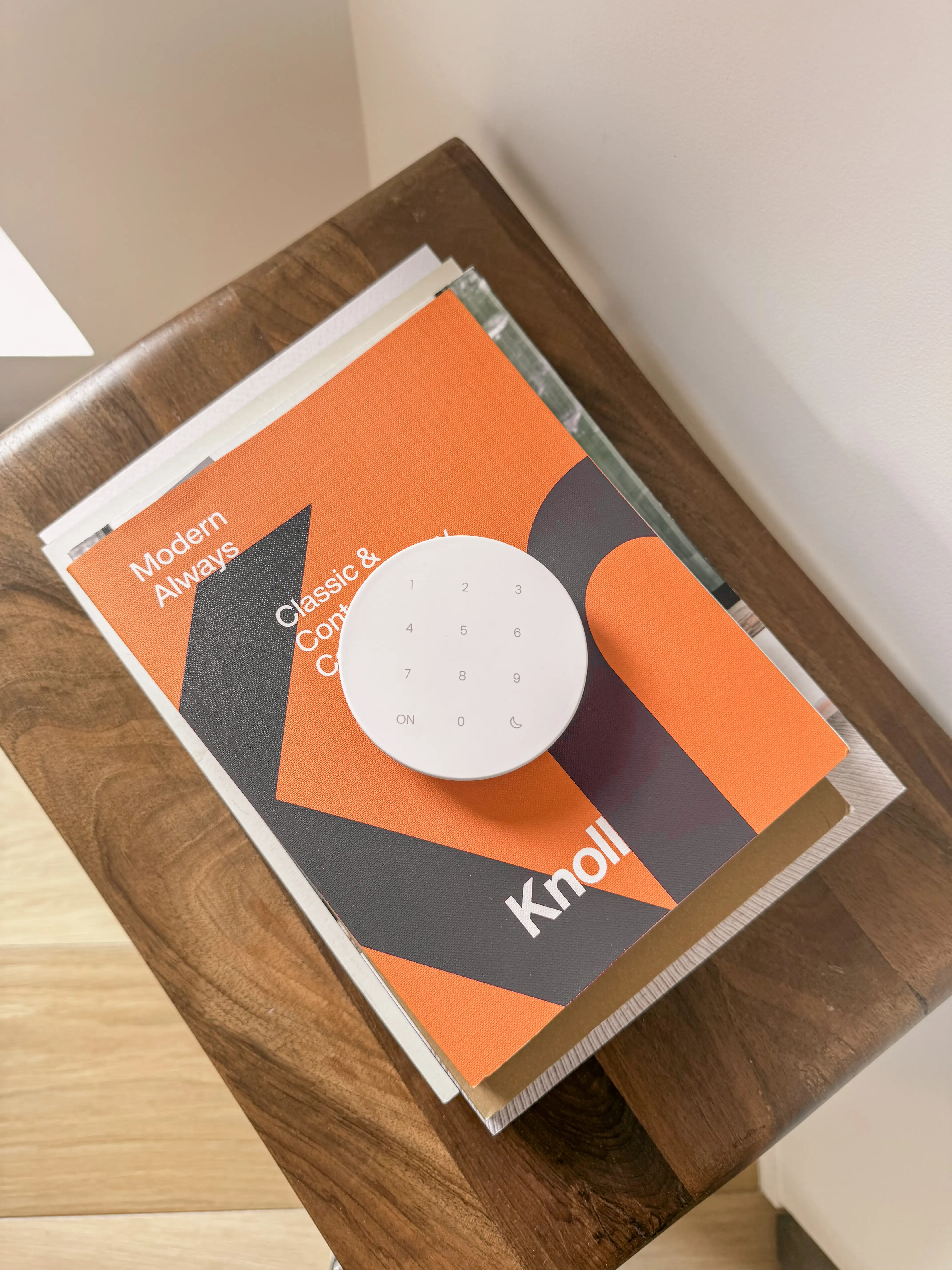 Qiara Keypad on a stack of magazines